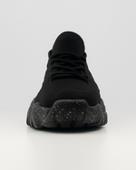 Frontal view of the black OrthoEase Luxe sneaker showing toe box and lace design with cushioned sole.