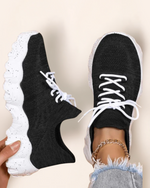 Top view of OrthoEase Luxe Oreo sneakers with black knit upper and white speckled sole