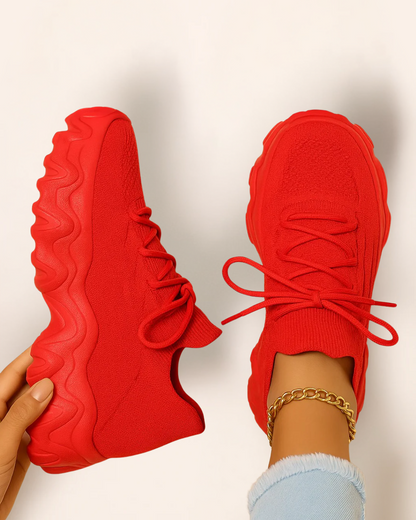 Top view of OrthoEase Luxe Crimson sneakers in vibrant red with matching sole