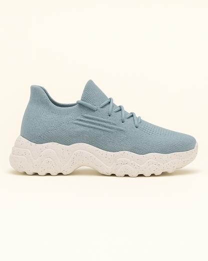 Left side view of OrthoEase Luxe Glacier sneakers in light blue knit with white sole