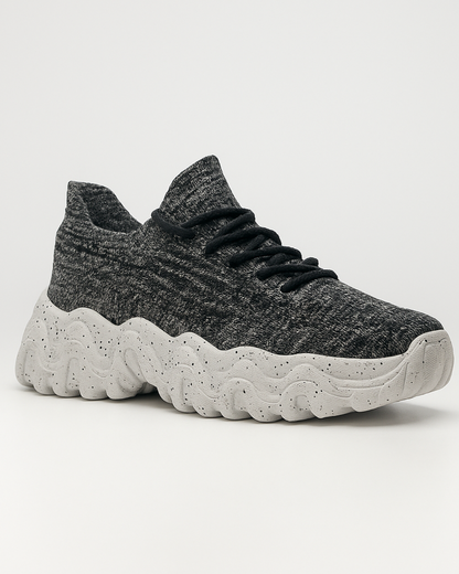 Angled view of OrthoEase Luxe Marble sneaker showing knit design
