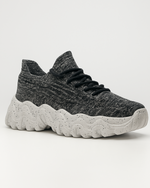 Angled view of OrthoEase Luxe Marble sneaker showing knit design