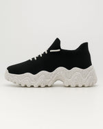 Left side of OrthoEase Luxe Oreo sneaker with white sole